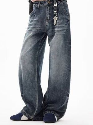 Men's blue denim wide-leg jeans with belt loops and button closure.