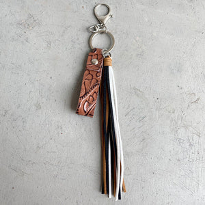 Textured leather tassel keyring with multi-colored fringe and silver hardware.