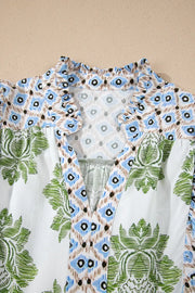 Vibrant floral patchwork mini dress with ruffled collar and V-neck.