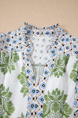 Vibrant floral patchwork mini dress with ruffled collar and V-neck.