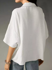 White half sleeve shirt with a relaxed fit and collared neckline.