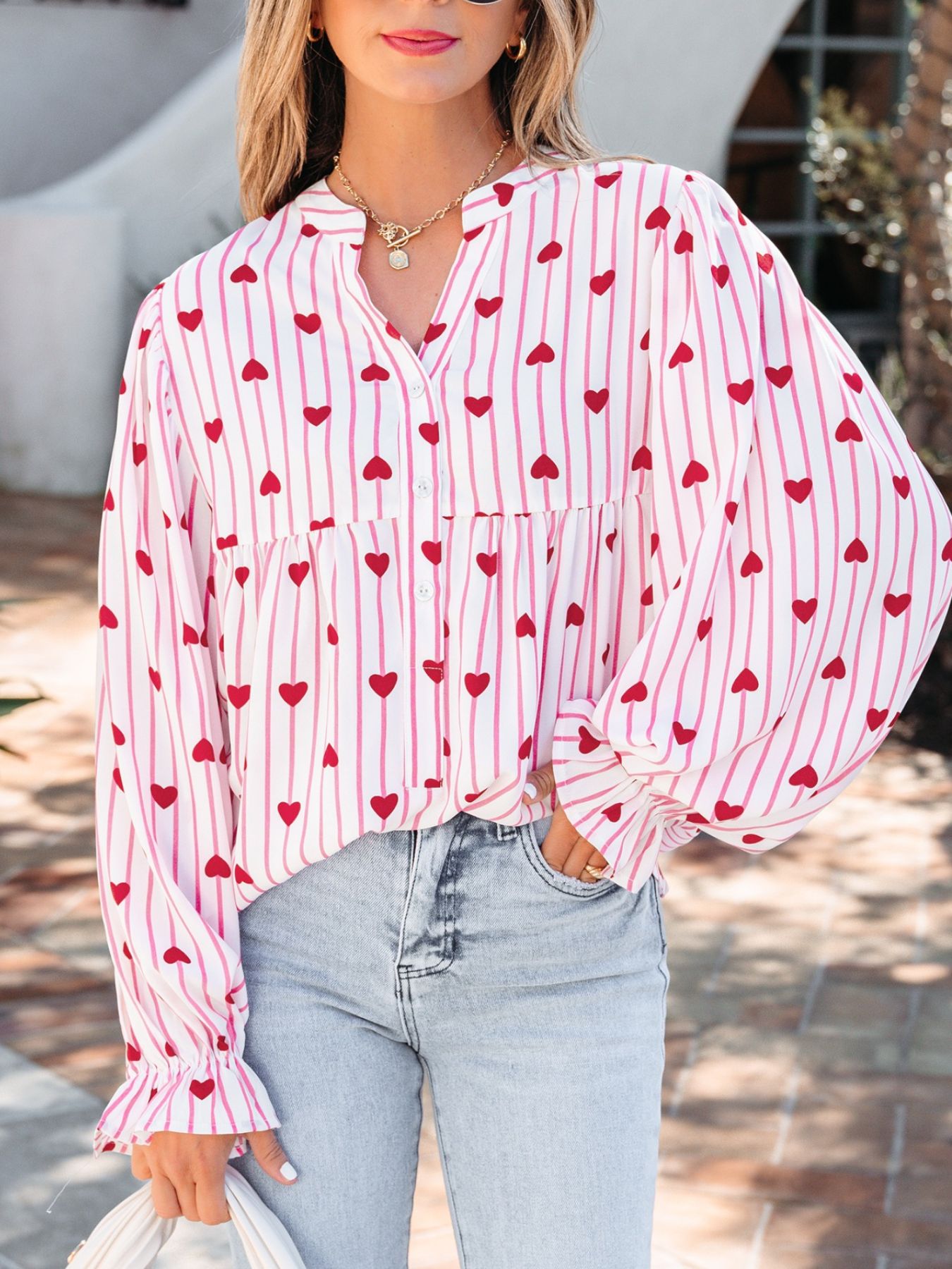 Maternity blouse with pink stripes and red hearts, button front, flounce sleeves.