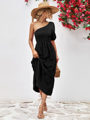 Black smocked bodice tiered one-shoulder dress with puff sleeve and ruffle hem.