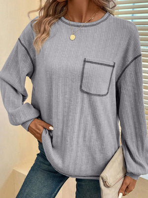 Gray ribbed knit sweater with contrast stitching on pocket and seams.