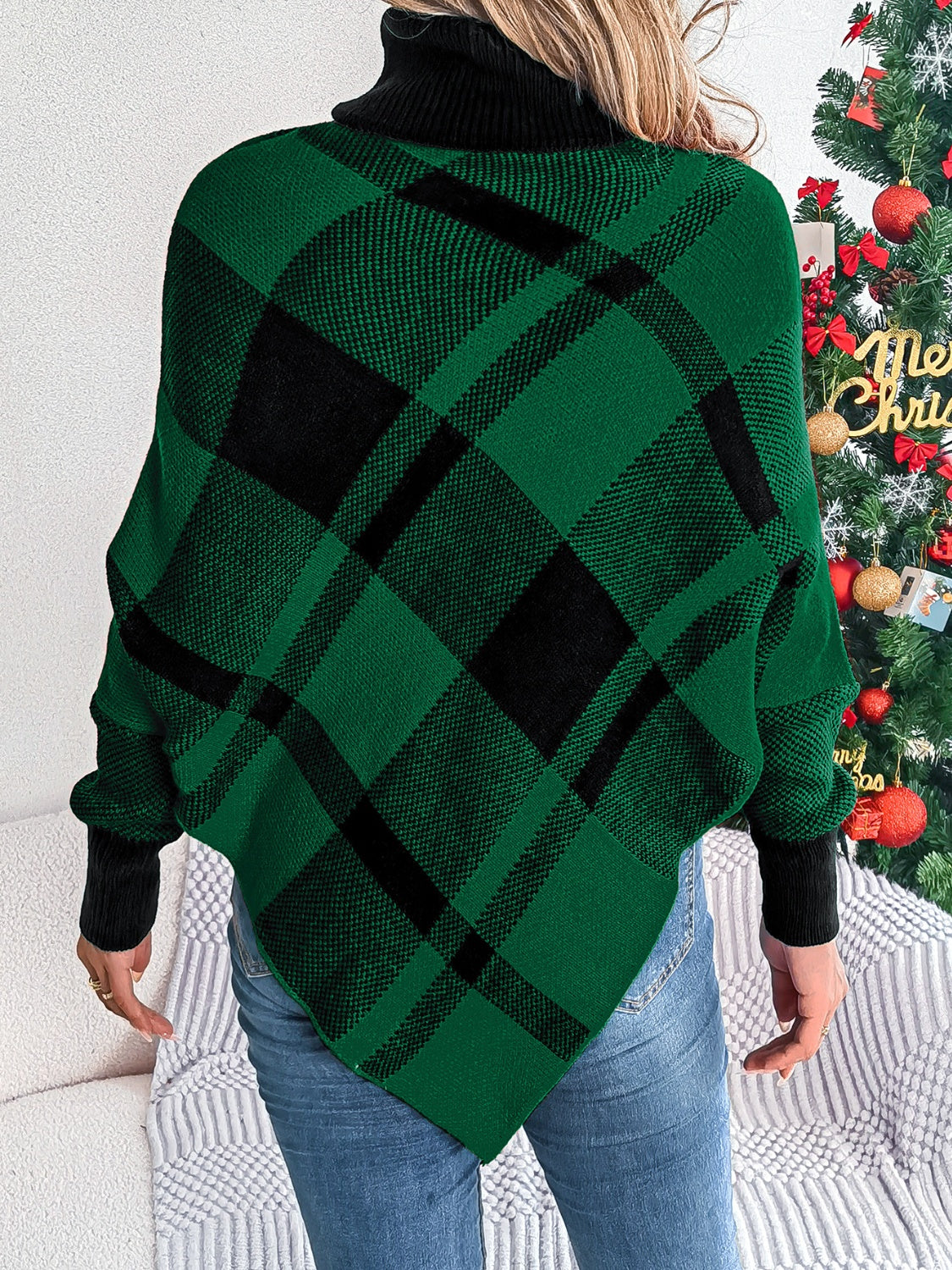 Green and black tartan turtleneck poncho sweater with asymmetric hem.