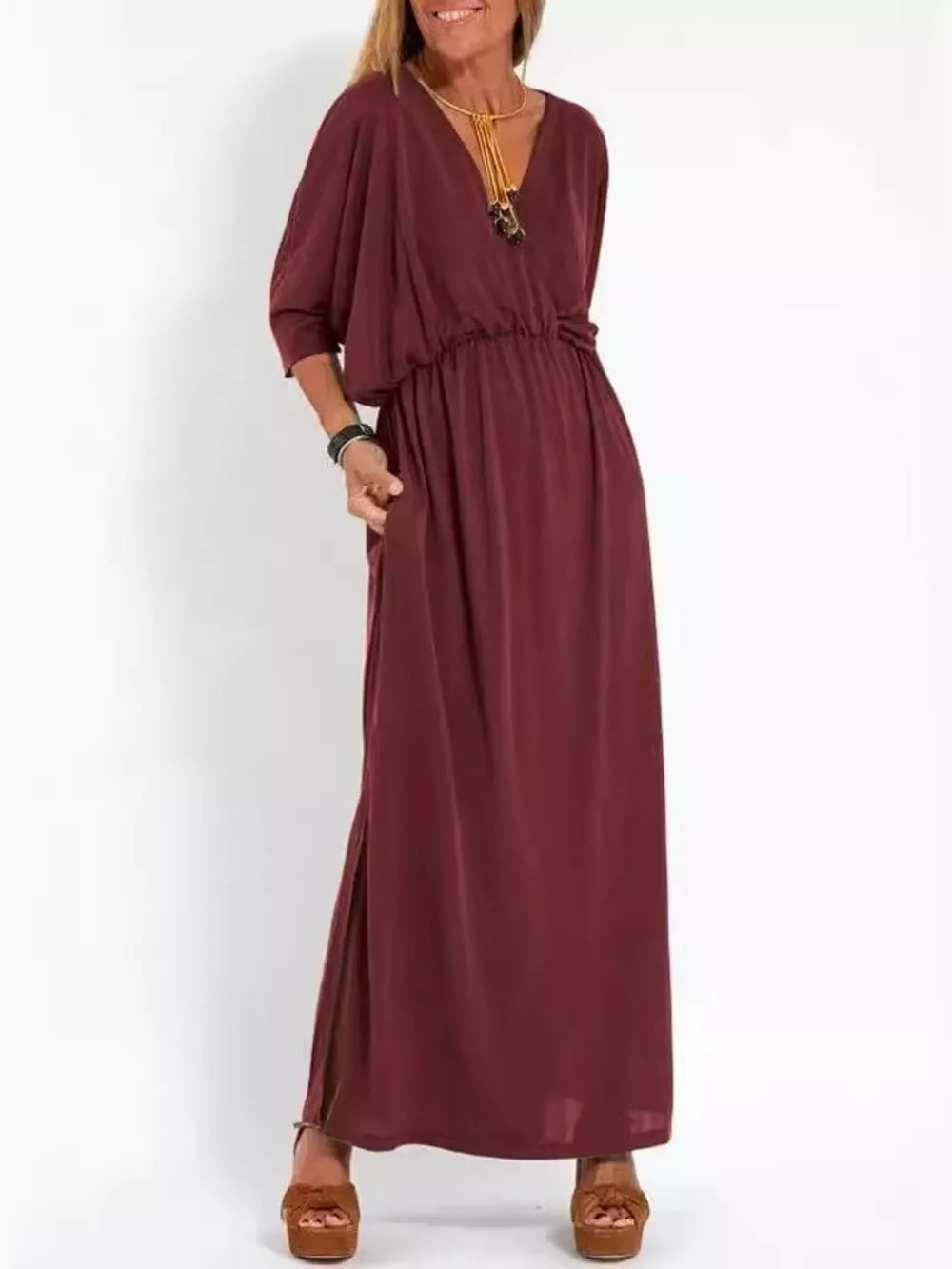 Wine red V-neck maxi dress with dolman sleeves, elastic waist, side slits, and pockets.