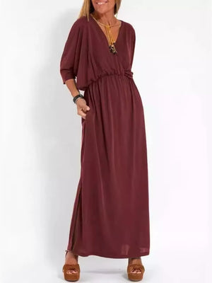 Wine red V-neck maxi dress with dolman sleeves, elastic waist, side slits, and pockets.