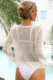 White open-knit beach cover-up with long sleeves and a relaxed fit.