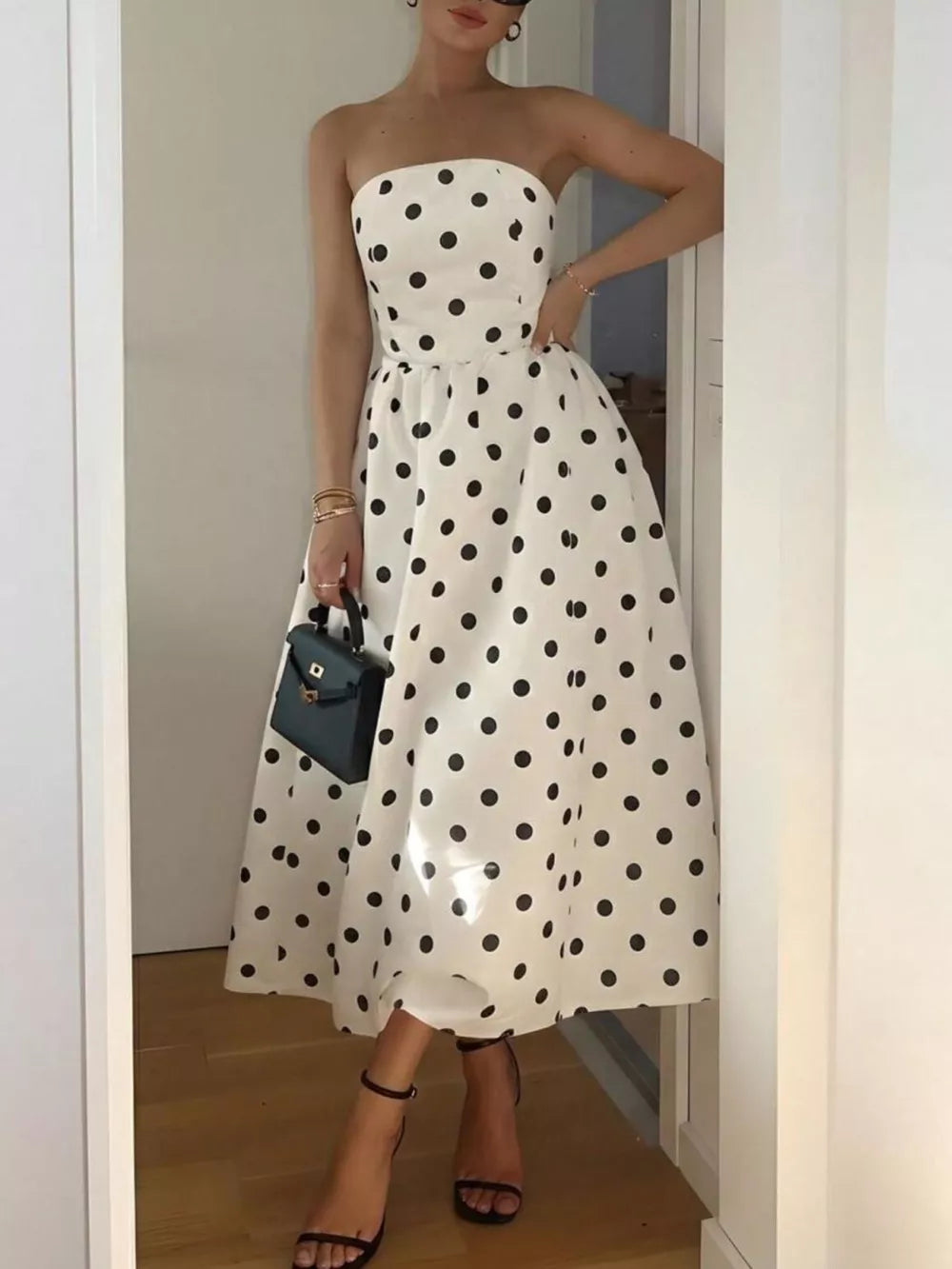 Cream polka dot strapless midi dress in polyester with A-line cut.