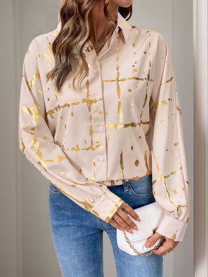 Tan blouse with gold brushstroke pattern, gathered sleeves, and button front.