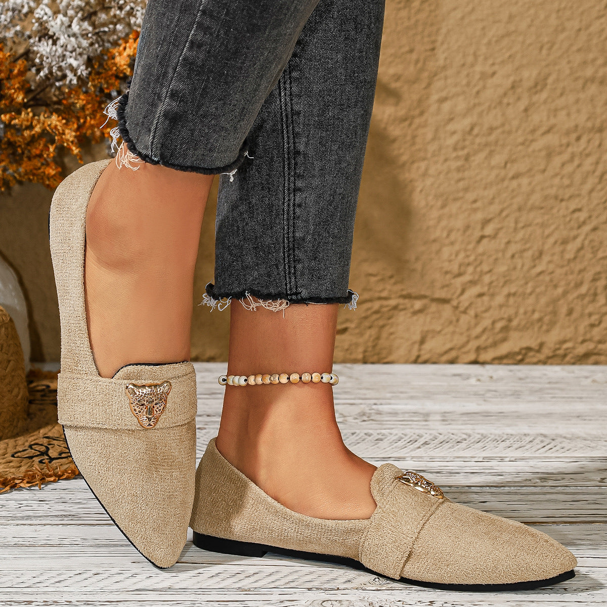 Point toe slip-on flats in apricot with animal print detail and a decorative buckle.