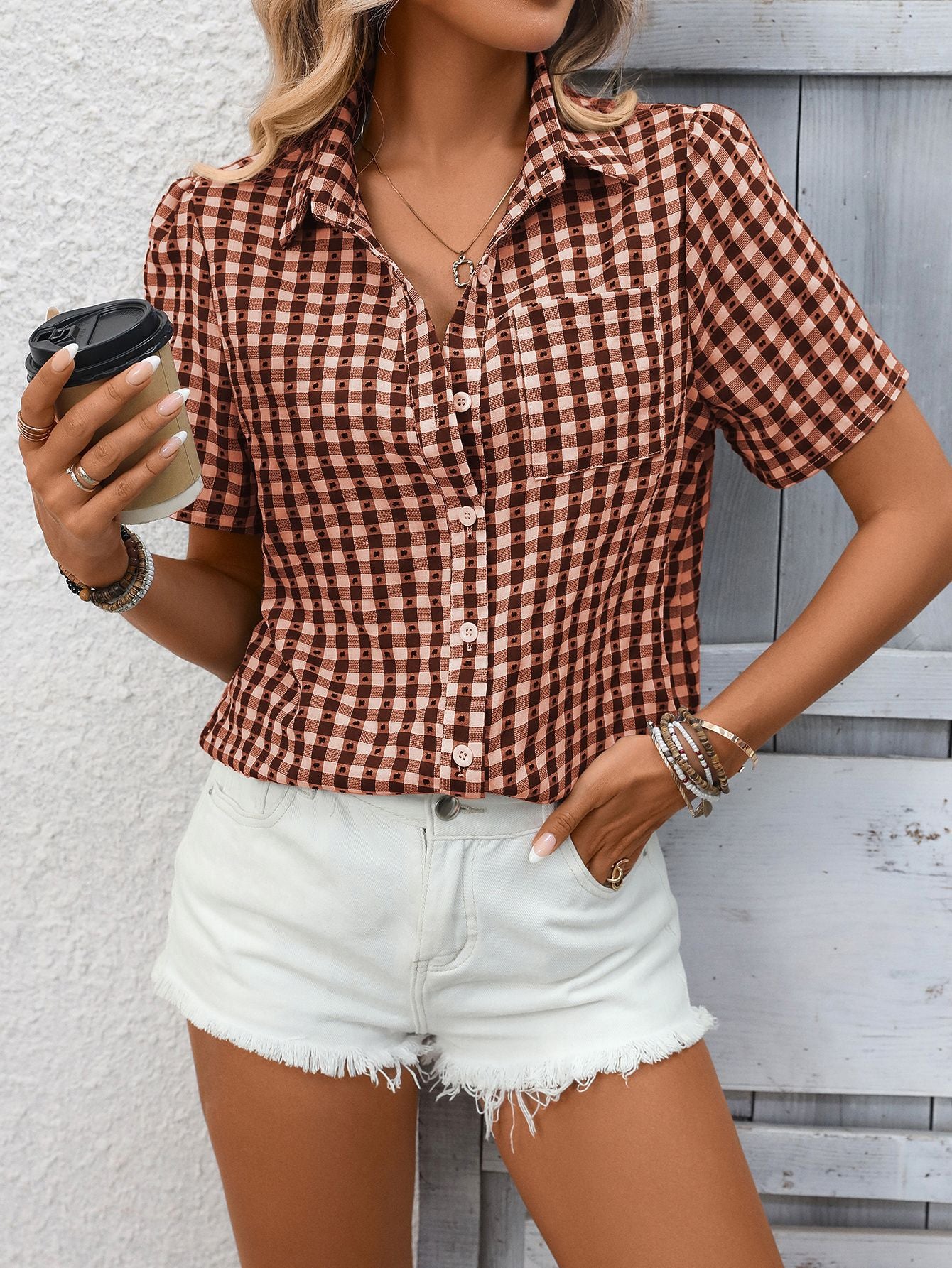 Gingham short-sleeve button-up shirt in Rust Red with a collared neckline and chest pocket.