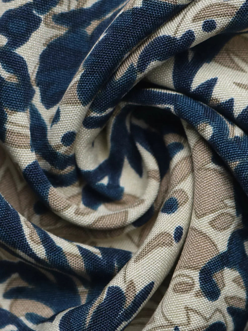 Ornate cap sleeve blouse with notch neckline in a blue and tan floral print fabric.