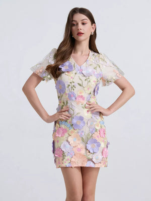 Embroidered floral mini dress with puff sleeves in a light, colorful floral pattern.