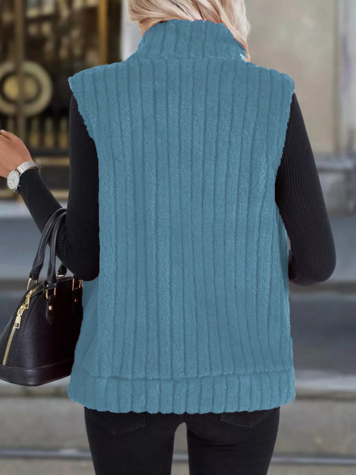 Sky blue fleece zip-up vest with ribbed texture and stand collar.