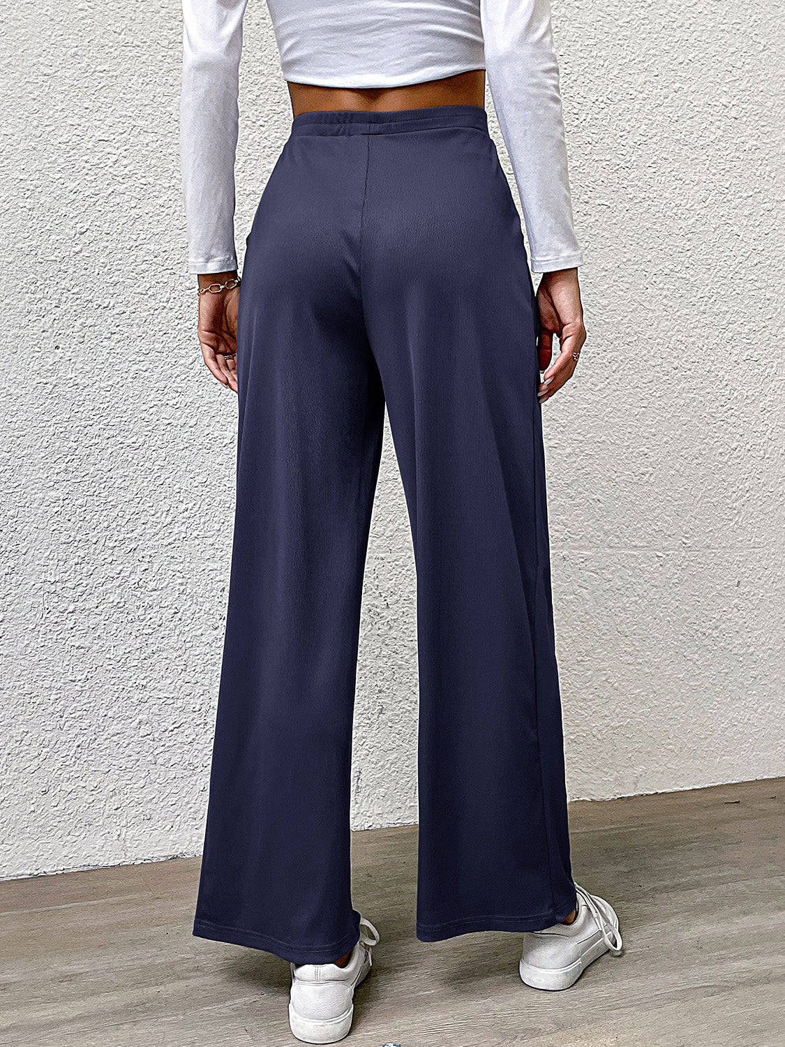 Navy wide leg trousers with a relaxed fit and elastic waistband.
