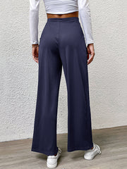 Navy wide leg trousers with a relaxed fit and elastic waistband.