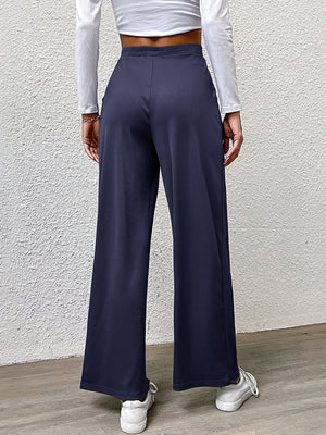Navy wide leg trousers with a relaxed fit and elastic waistband.