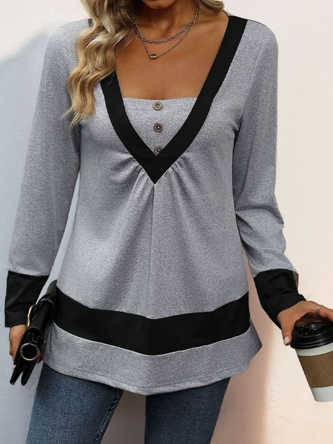 Gray long sleeve blouse with contrast black V-neck yoke and hem detail.