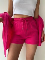Hot Pink textured gauze shorts with drawstring waist and matching open button-up shirt.