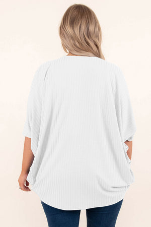 White ribbed batwing cardigan with short sleeves and a draped front.
