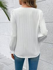 White textured pleat blouse with lace trim cuffs and long puff sleeves.