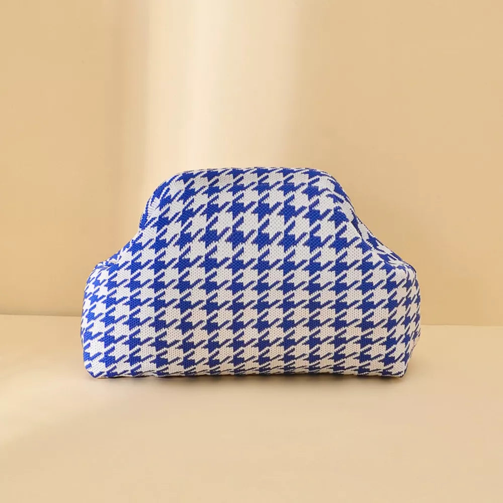 Vibrant knit clutch bag with striking blue and white houndstooth pattern