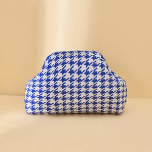 Vibrant knit clutch bag with striking blue and white houndstooth pattern