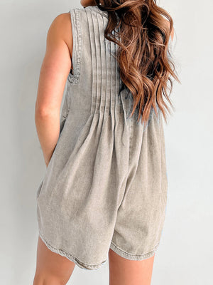 Pleated denim playsuit in mocha, sleeveless with a tie-front detail and A-line shorts.
