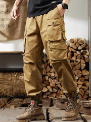 Khaki cargo pants with multiple pockets and elastic cuffs.