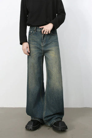 Dark wash wide-leg denim jeans with a relaxed fit and faded details.
