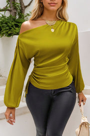 Matcha green asymmetric blouse with drape-front and ruched side detail.