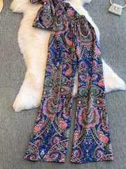 Chic cami and wide-leg pant set in navy with colorful paisley print.