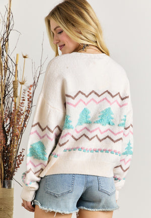 White knit sweater with textured tree motif and zigzag pattern.