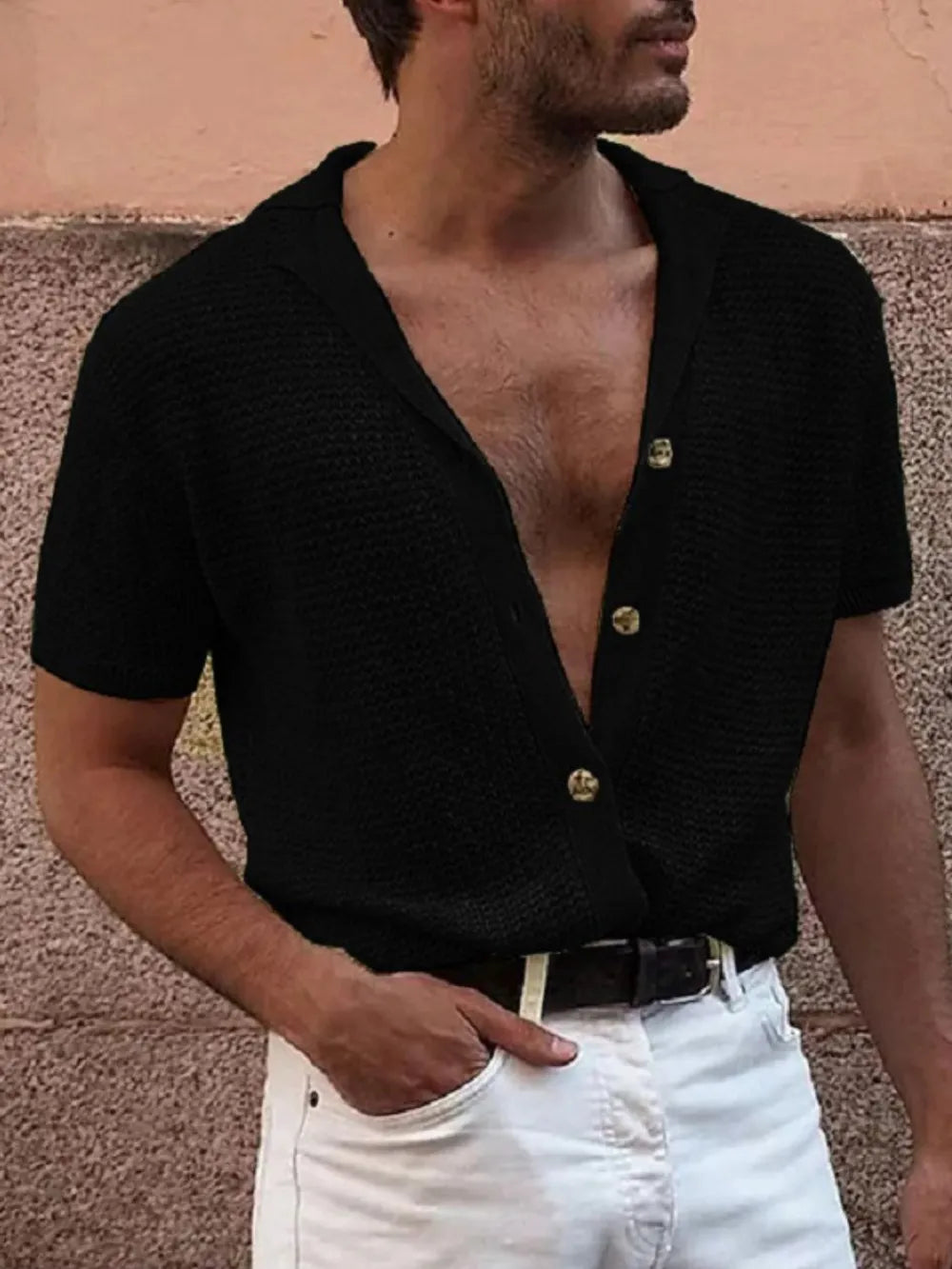 Black textured knit resort shirt with gold buttons and open collar.