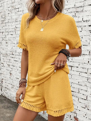 Textured knit outfit set in gold with fringe detail on sleeves and shorts.