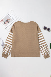 Camel knit top with asymmetrical checkered and striped sleeves