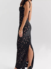 Black floral lace maxi dress with tie shoulder, cutout detail, and high slit.