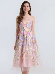 Pink midi dress with strapless neckline and intricate floral appliques.