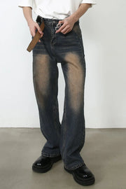 Baggy dark wash denim jeans with faded detailing and a relaxed fit.