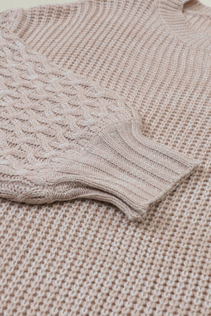 Tan knit sweater with diamond textured sleeves and ribbed cuffs.