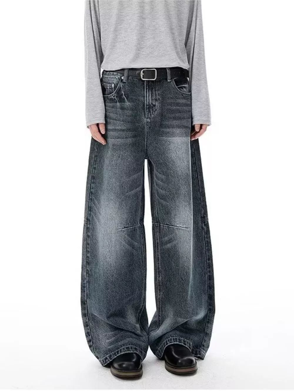 Men's vintage-inspired wide-leg jeans in washed black denim with a black belt.