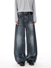 Men's vintage-inspired wide-leg jeans in washed black denim with a black belt.