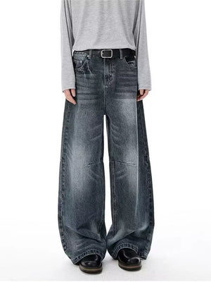 Men's vintage-inspired wide-leg jeans in washed black denim with a black belt.
