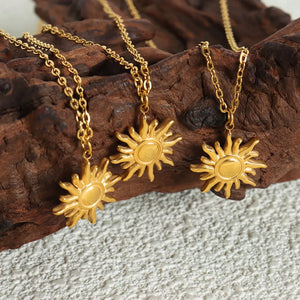 Gold sunburst pendant necklace with adjustable chain, 18K gold-plated.