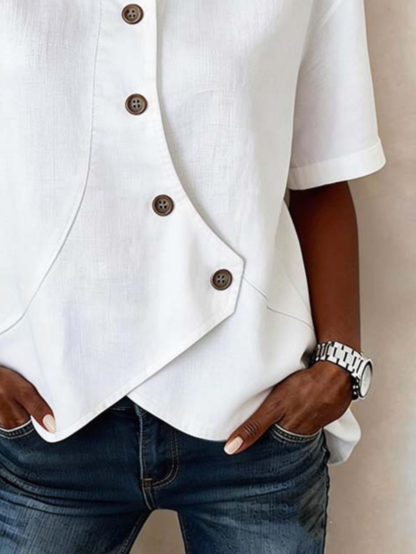 White asymmetrical button front shirt with diagonal placket detail.