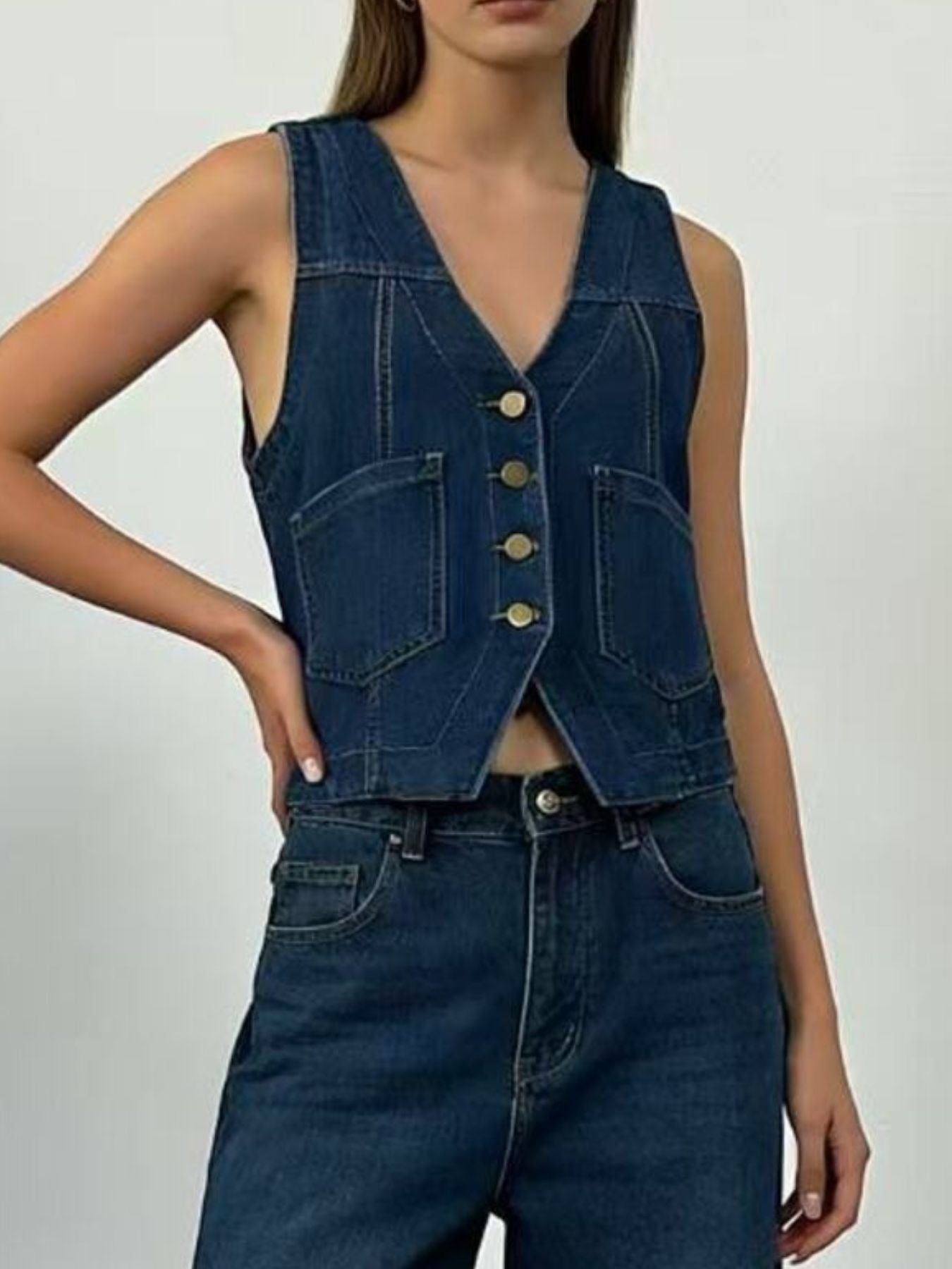 Plus size dark blue denim vest with brass buttons and cropped length.
