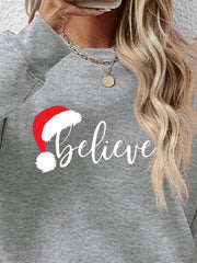 Gray raglan sweatshirt with white "Believe" text and Santa hat graphic