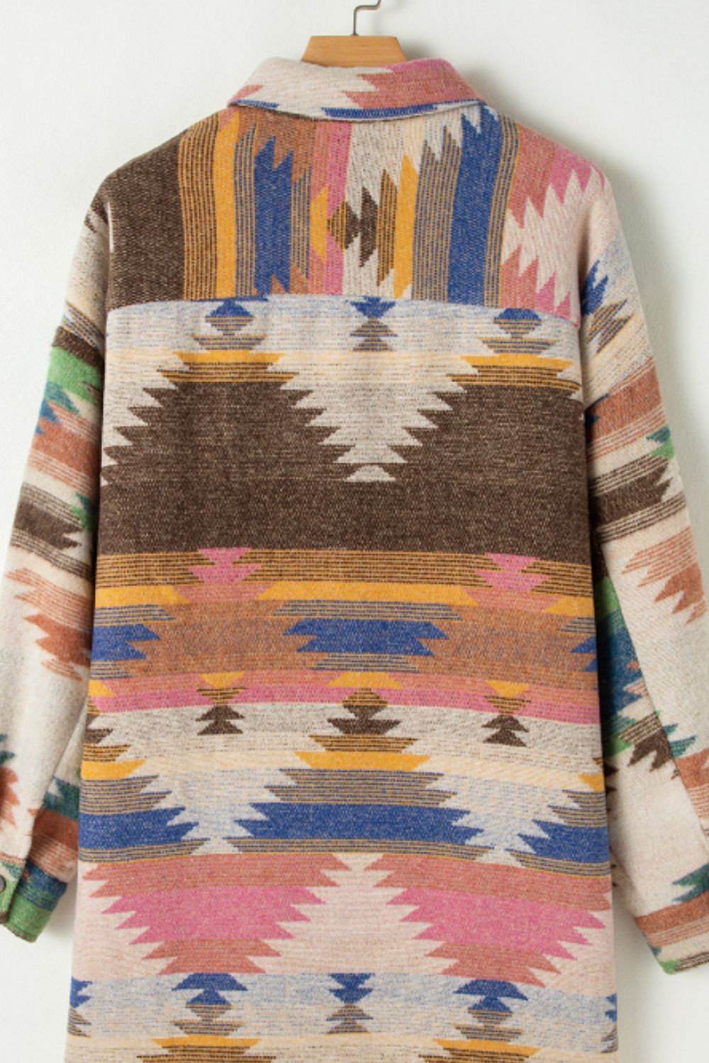 Southwestern print shirt jacket in beige with button closure and colorful geometric pattern.