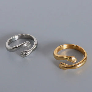 Embracing Hands open ring in gold and silver, a chic accessory for women.